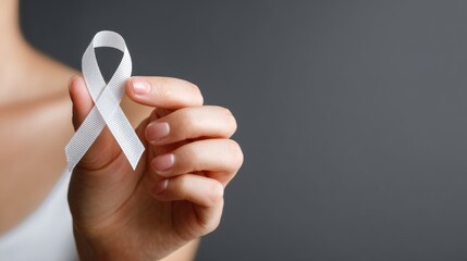 female hand hold white ribbon lung cancer health care concept