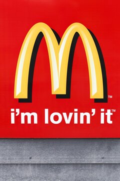Aarhus, Denmark - June 21, 2015: McDonald's logo on a facade. McDonald's is the world's largest chain of hamburger fast food restaurants