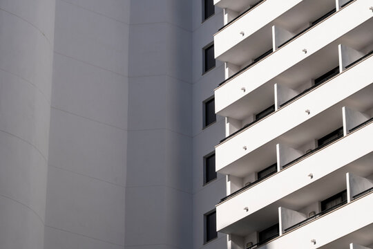 Modern architecture facade balconies pattern with crisp lines and shadow in urban minimalism leaving space for text and graphic design
