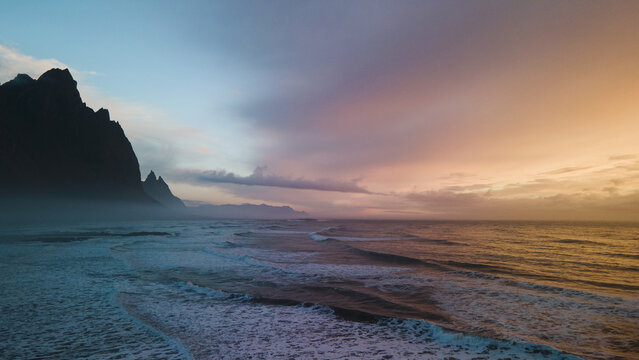 sunset over the sea in iceland at stokksnes