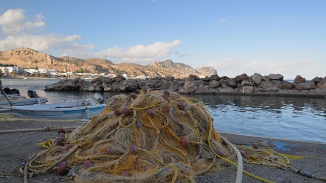 Fishing nets and boats on the shore at Stegna on Rhodes island in Greece