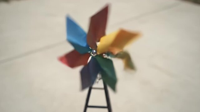 Spinning Colorful Pinwheel Outdoors on Concrete Surface