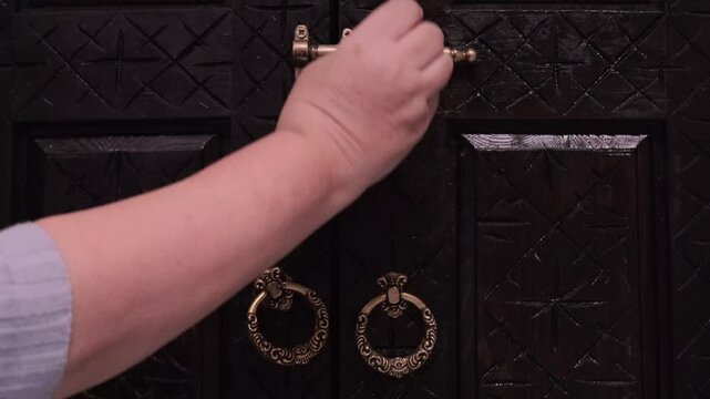 Elegant hands touch carved wooden wardrobe in Moroccan riad, emphasizing artisanal beauty and cultural heritage, Traditional Arabic home decor, exotic vintage decor, authentic experience