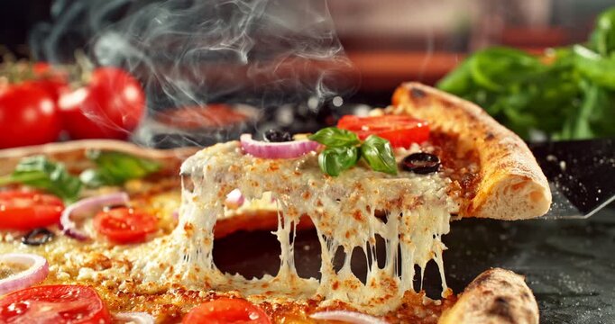 Super slow motion footage (1000 fps) of a pizza slice being lifted with perfectly melted, stretchy cheese. Rich textures of crust, tomato and fresh basil in cinematic light.