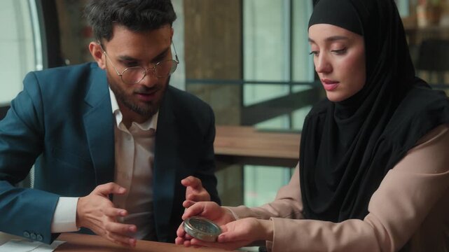 Muslim business team with compass corporate navigate Indian businessman Arabian businesswoman in hijab two entrepreneurs agents searching direction navigation in financial strategy company development