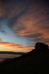 stunning view of a sunrise between fog ans sky