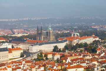 Fototapeta premium Aerial view of Prague Castle and St. Vitus Cathedral above red roofs, Hradcany, Prague, Czechia. g.
