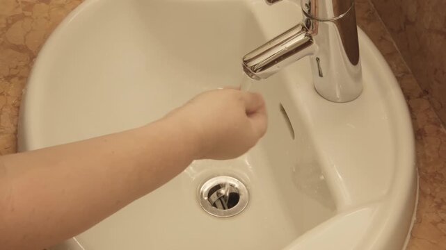 Woman brushing her teeth in front sink, practicing daily oral hygiene, preventing gum inflammation and periodontitis, healthy teeth, gums and dental care routine, Morning ritual for strong teeth