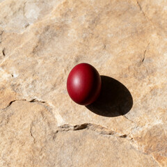 Minimal Orthodox Easter concept with red egg and long shadow
