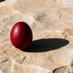 Minimal Orthodox Easter concept with red egg and long shadow