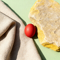 Orthodox Easter red egg on linen and stone texture background