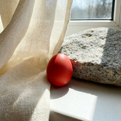 Orthodox Easter red egg on linen and stone texture background