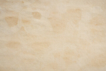 Obraz premium Old vintage paper texture background with aged stains and antique yellowed parchment effect