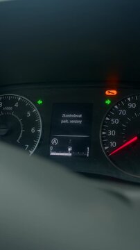 Car panel alert, Vehicle dashboard showing warning signals and sensor information details, Detailed view of automobile dashboard with warning lights and active sensor notifications