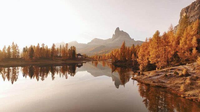 Reflections is in water. Lake Federa near the Croda da Lago mountain at autumn time, majestic landscape, raw nature.