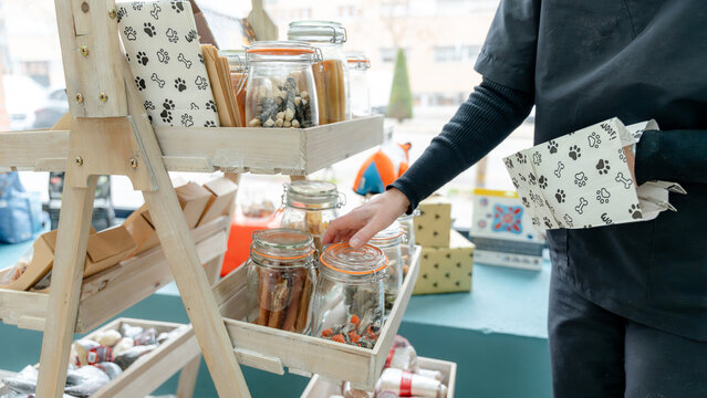 Dog grooming salon treats display in wooden shelves