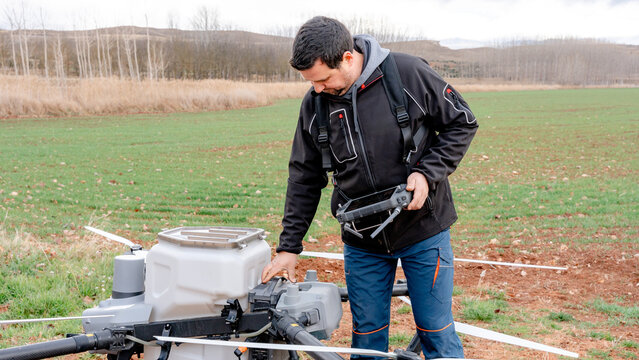 Farmer checking agricultural drone system