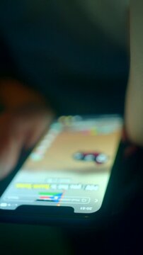 thumb scrolling vertical video on phone screen, blue glow and shallow depth of field, focused fingertips interacting with social feed, latenight entertainment and shortform content vibe