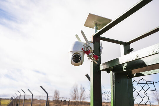 Outdoor surveillance camera in a fenced field
