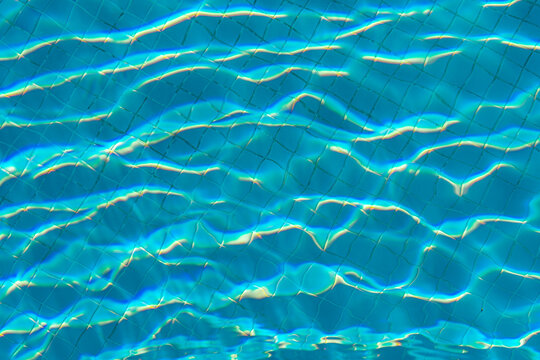 Turquoise pool water with sunlight reflections