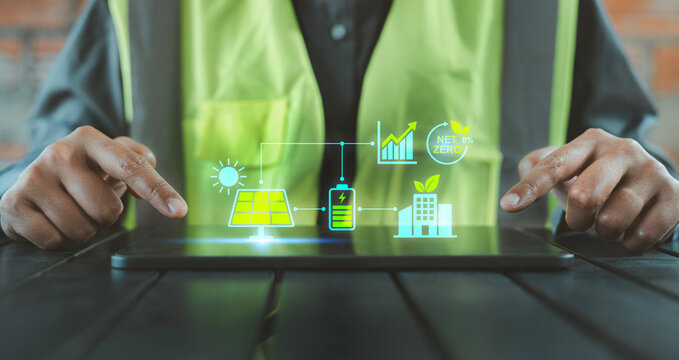 Renewable energy, Innovation Ecology Sustainable construction, Worker hands using tablet with smart energy management interface and net zero building data analytics holograms