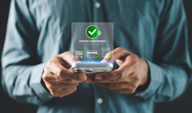 successful online shopping, approved payment, ecommerce checkout completion, Man holding smartphone with green order confirmed check mark and thank you message for mobile shopping success concept