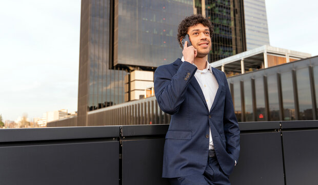 Businessman talking on phone in urban environment