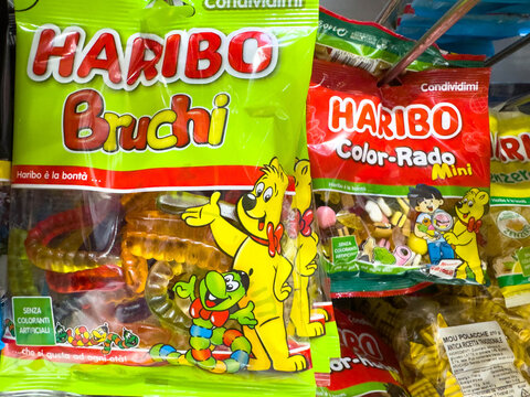 Venice, Italy - February 14, 2026: Haribo gummy candy packages featuring Bruchi and Color-Rado Mini varieties displayed on a store shelf with colorful designs and branding