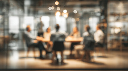 A blurry image of a group of business people sitting in a meeting.