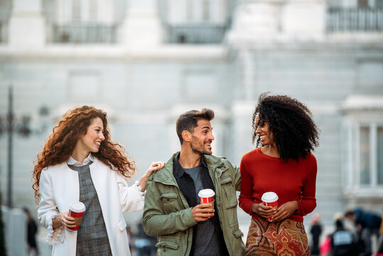 Friends enjoying coffee in Madrid street