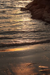 Golden Sunset Reflections on Ocean Waves and Rocks