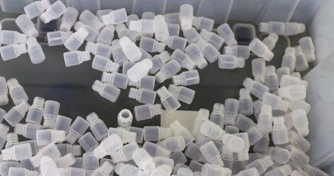 Plastic bubbles fall into a tank. Modern plastics production.