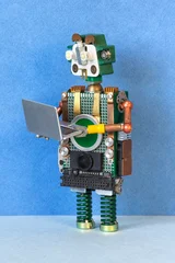 Robot with open laptop in hands, standing pose. Digital learning concept, online education poster, tech gadget banner © besjunior