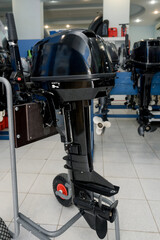 Outboard motors are displayed on stands in the sales area.