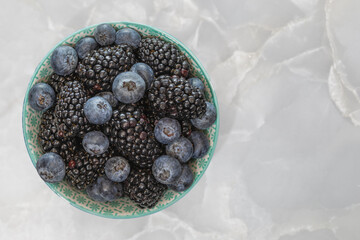 Bowl of Blackberries and Blueberries in a Bowl on Gray Marble