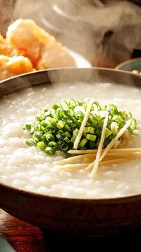 Steaming hot bowl of Asian rice porridge with green onions