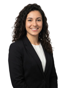 Professional young businesswoman with curly dark hair smiling confidently in a studio portrait.