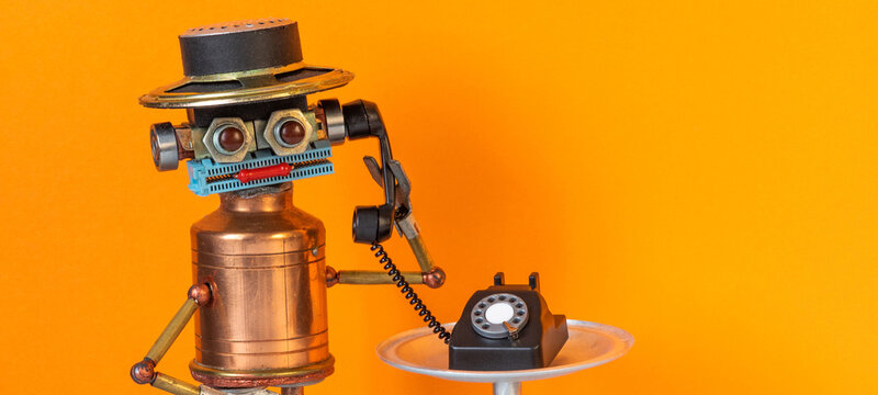 Robot bot operator holds handset rotary telephone. The concept of a hot line phone service for customer support, consultation using answering machine robots trained artificial intellect technology.
