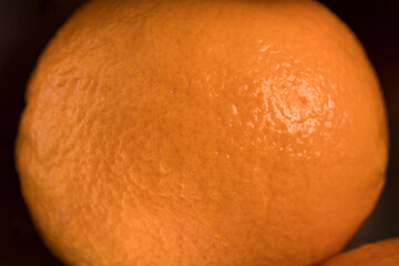 Macro close-up of Dekopon (Shiranui) orange peel showing detailed natural citrus texture and vibrant surface. Ideal for food backgrounds, citrus concepts, and fresh fruit visuals.
