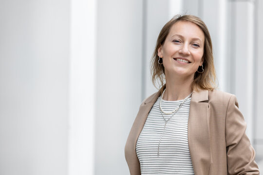 Portrait of young adult mid age businesswoman in formal dress suit outdoors. Happy confident stylish elegant business woman female person. Financial Management IT professional corporate people