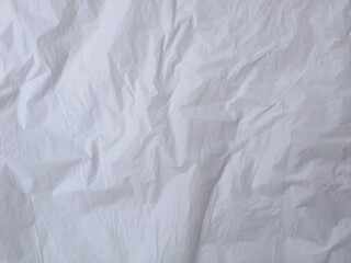 Obraz premium Crumpled white plastic texture background with creases and folds. Perfect for industrial, environmental, or minimalist design concepts