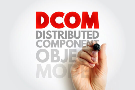 DCOM Distributed Component Object Model concept. Hand holding pen writing acronym text. Software architecture, communication, and integration background