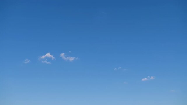 Brilliant blue sky with a few wispy, white clouds floating serenely