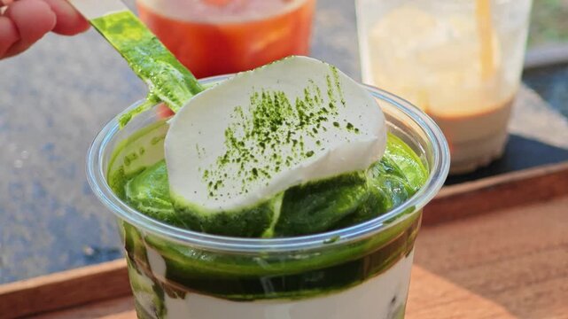 Matcha latte with cream on top.
