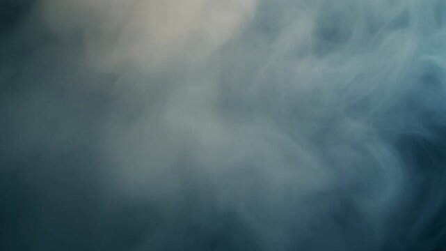 Foggy mist swirling over a dark blue landscape viewed from a high vantage point, capturing the eerie atmosphere and natural scenery