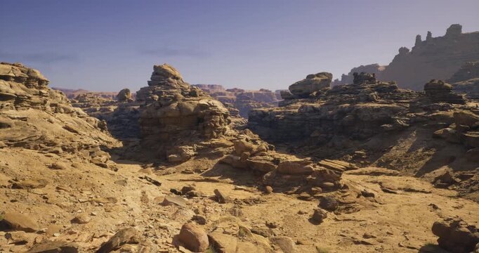 Stunning rocky outcrops rise from the sandy ground, set against a clear blue sky. The sunlight accentuates the unique shapes and textures of the desert terrain.