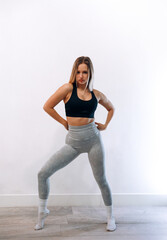 Fototapeta premium Portrait Of Beautiful Young Female Doing Exercising. Woman Stretching, And Enjoying Fitness Training And Healthy Lifestyle. Yoga For Health