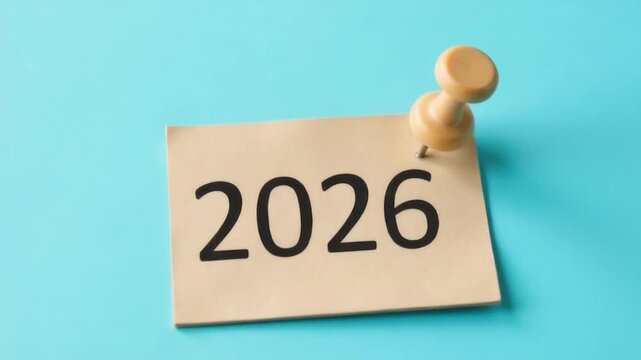 A note stuck to a blue wall with the year 2026 written on it