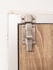 Stainless Steel Slide Bolt Latch on Wooden Door.