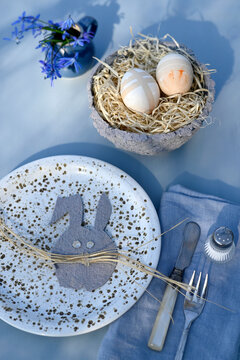 Easter table decoration with handmade bunny and painted eggs